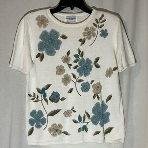 Cream colored short sleeve knit sweater with turquoise & tan embroidered flowers